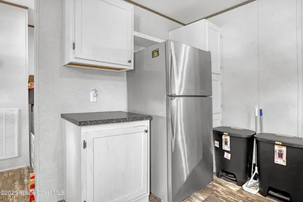 a white refrigerator freezer and a stove sitting inside of a kitchen