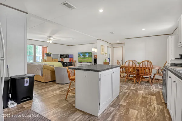 a kitchen with lots of counter top space and furniture