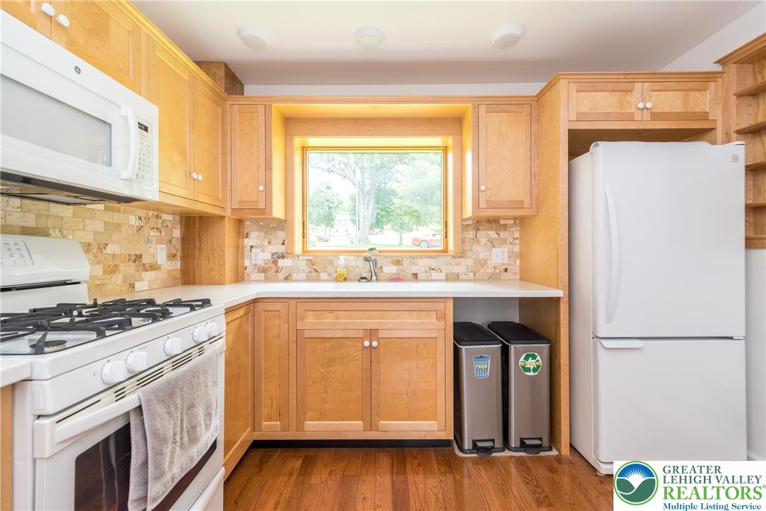 1815 Leithsville Road Hellertown, PA 18055 - Photo 4 of 38 A well-lit kitchen with natural wood cabinetry and resilient hardwood flooring.