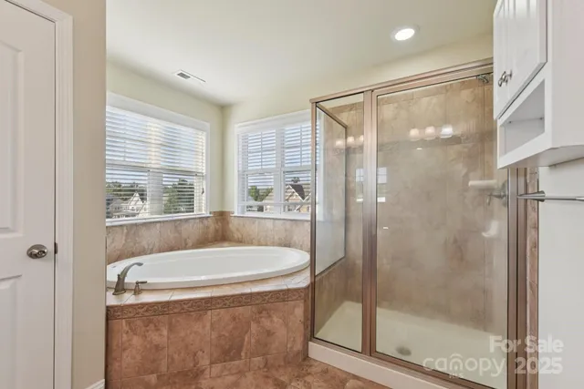 a bath tub sitting next to a shower