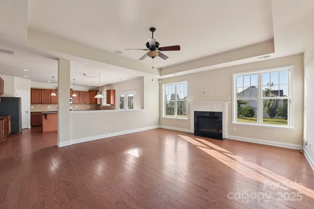 an empty room with windows fireplace and windows