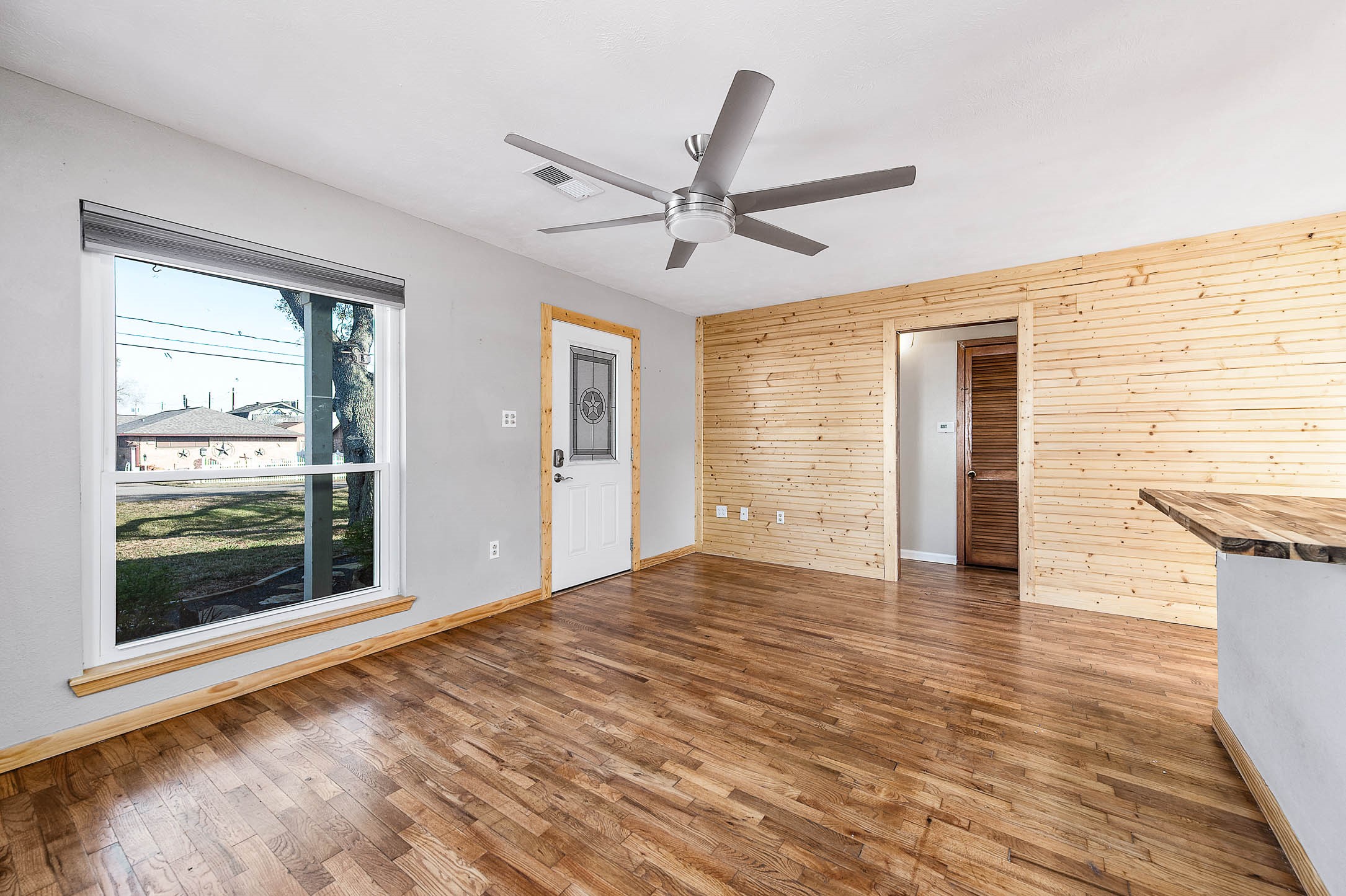2738 Lilac Street Pasadena, TX 77503 - Photo 13 of 26 a view of an empty room with a window and wooden floor