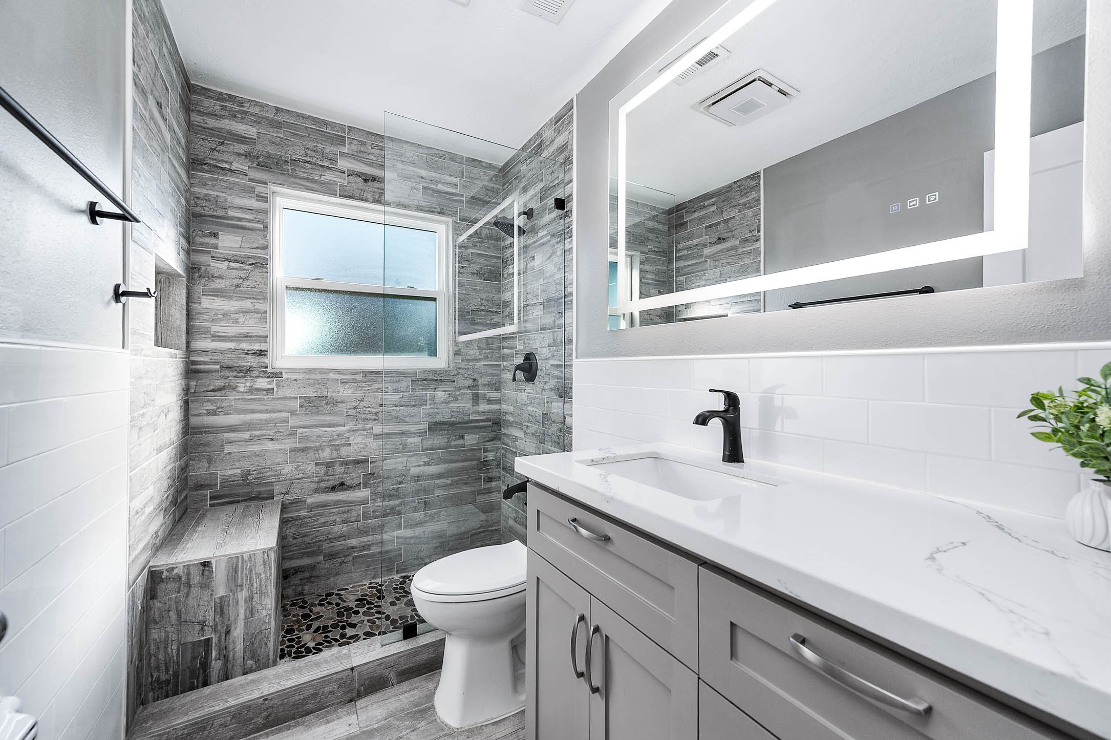 2738 Lilac Street Pasadena, TX 77503 - Photo 17 of 26 a bathroom with a granite countertop toilet sink and mirror