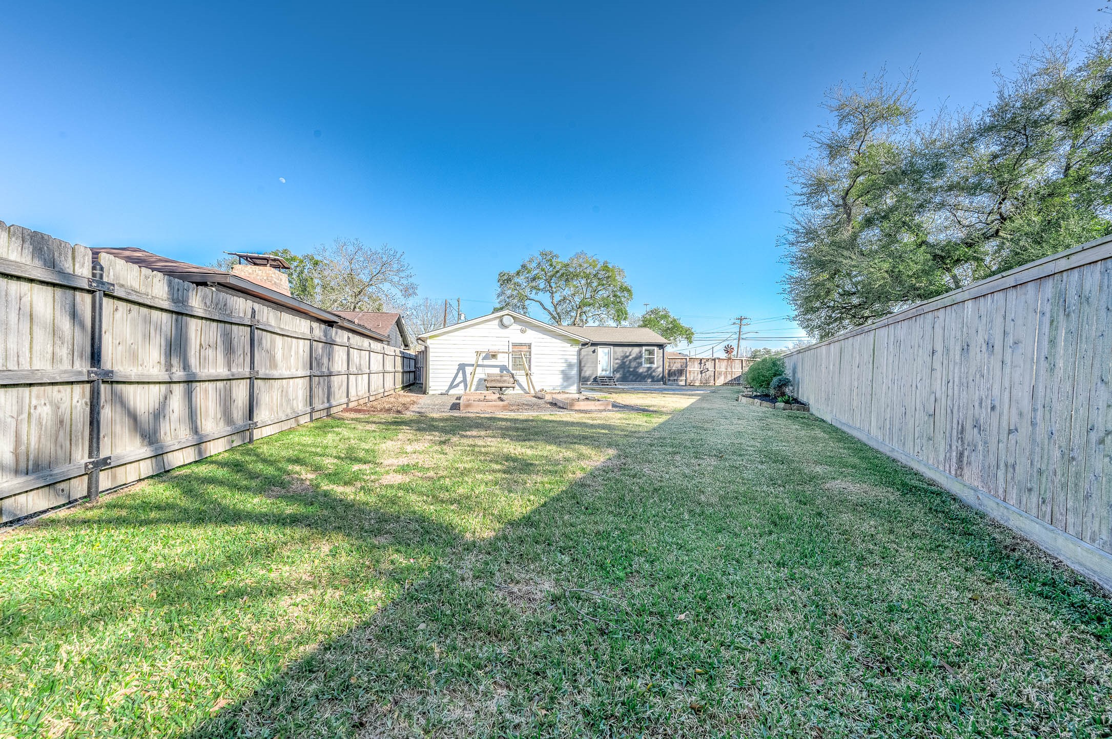 2738 Lilac Street Pasadena, TX 77503 - Photo 25 of 26 a backyard of a house with table and chairs