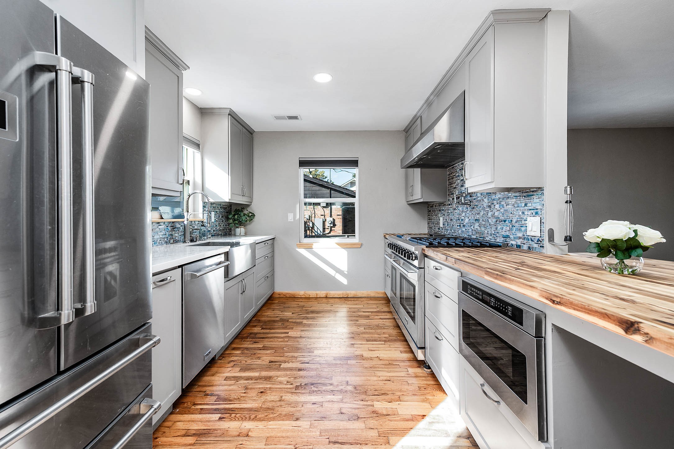 2738 Lilac Street Pasadena, TX 77503 - Photo 8 of 26 a large kitchen with granite countertop a large counter top space a sink stainless steel appliances and cabinets