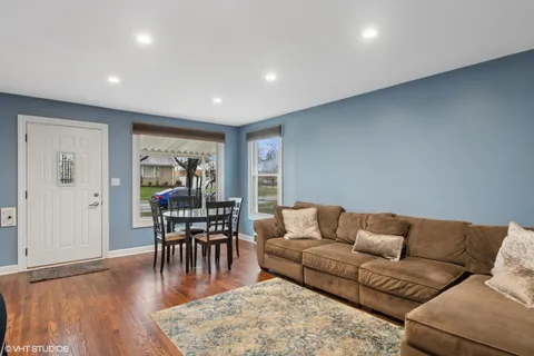 a living room with furniture and wooden floor