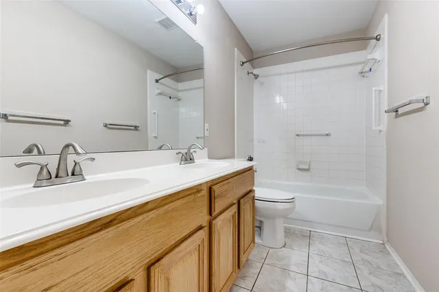 a bathroom with a double vanity sink toilet mirror and shower