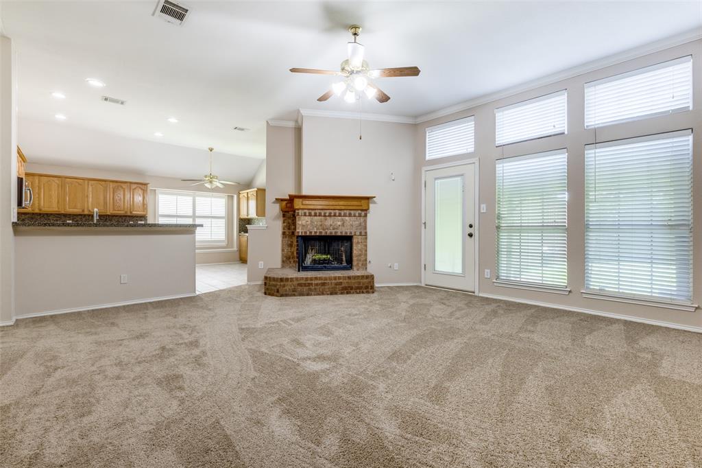 2603 Tourette Court McKinney, TX 75070 - Photo 4 of 16 a view of an empty room with a fireplace and a window