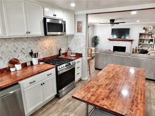 a kitchen with a stove and a white cabinets