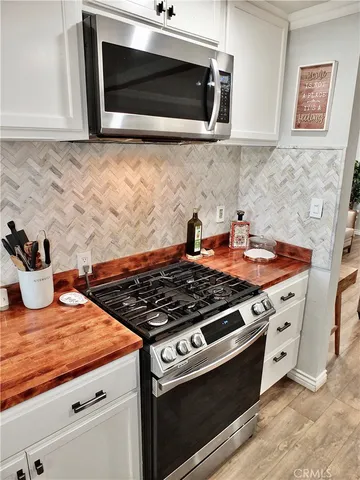 a stove top oven sitting inside of a kitchen