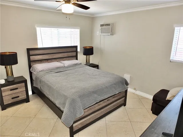a bedroom with furniture and flat screen tv