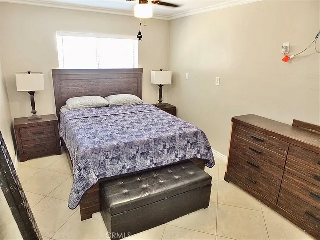 a bedroom with a bed and a mirror