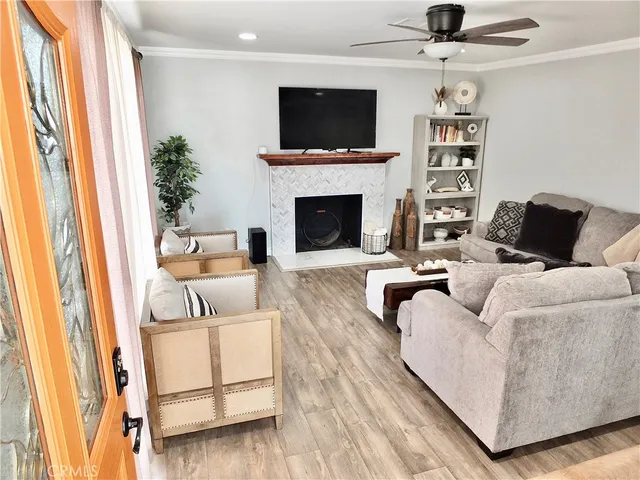 a living room with furniture a flat screen tv and a fireplace