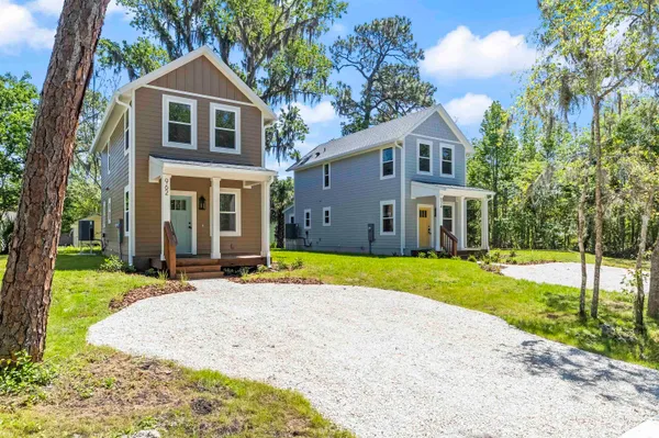 an aerial view of a house with a yard and garden