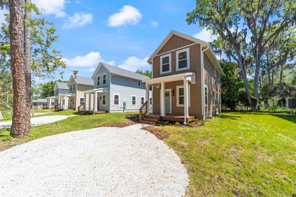 a view of a house with wooden floor and a yard