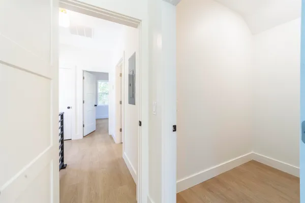 a view of a room with wooden floor