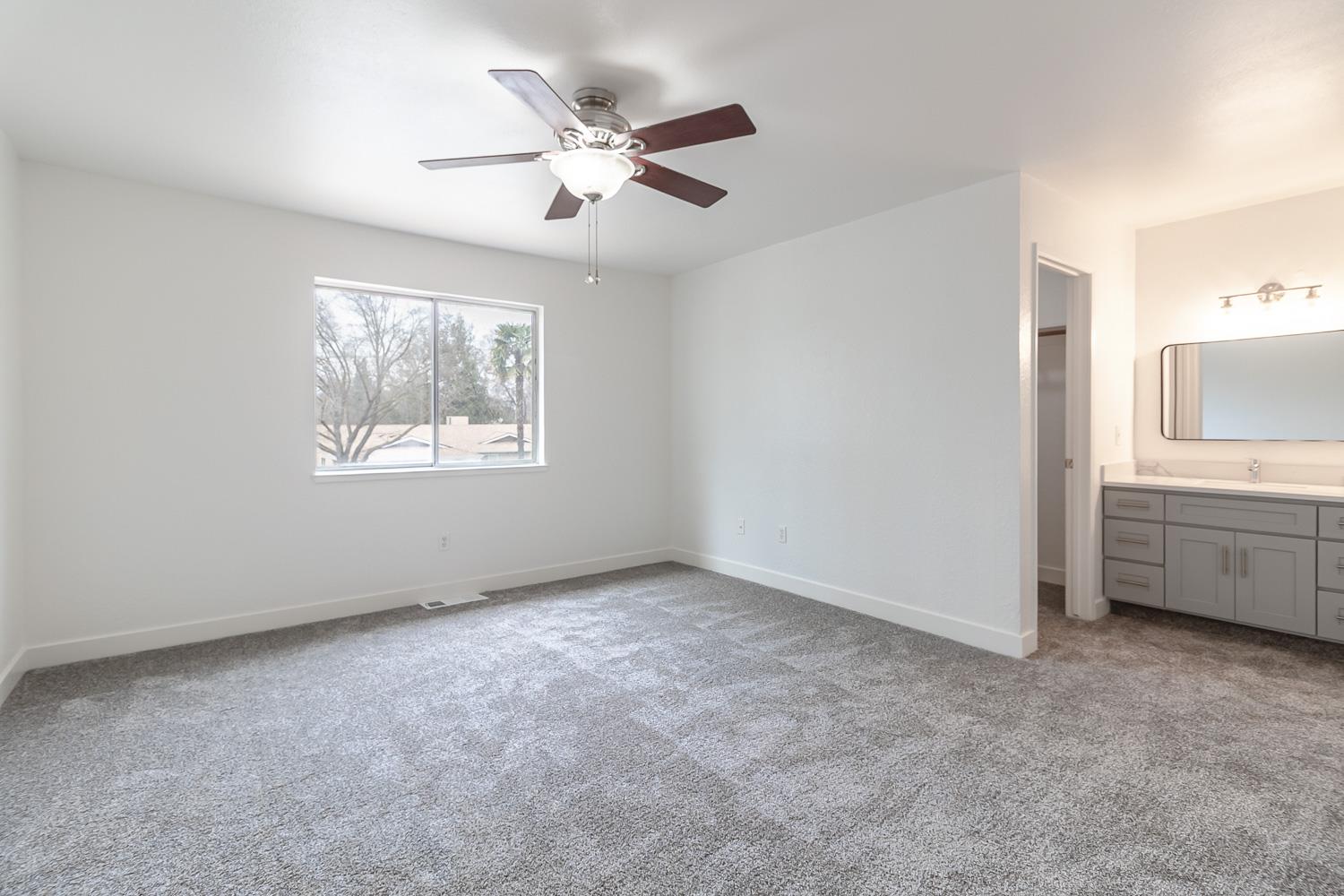 1128 Diablo Avenue Modesto, CA 95358 - Photo 17 of 23 an empty room with windows and fan