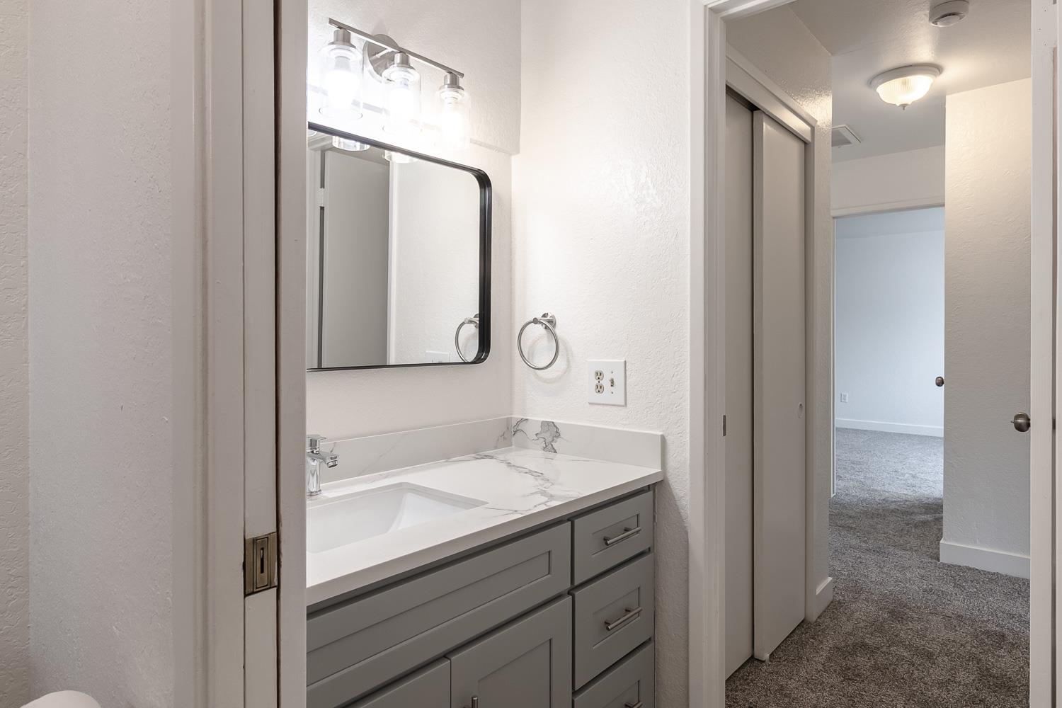 1128 Diablo Avenue Modesto, CA 95358 - Photo 20 of 23 a bathroom with a sink vanity and a mirror