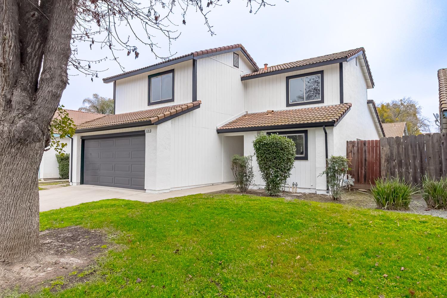 1128 Diablo Avenue Modesto, CA 95358 - Photo 3 of 23 a view of a house with a yard and a garden