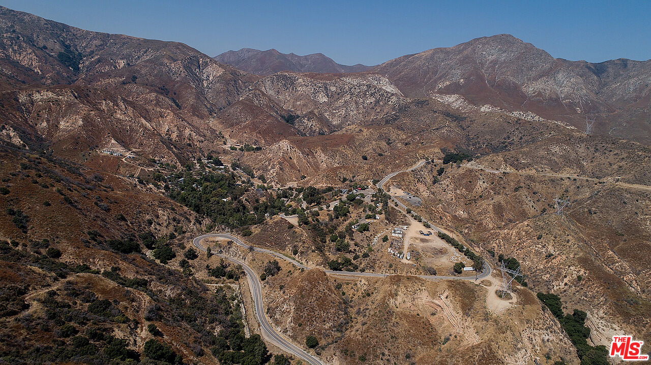 14831 Little Tujunga Canyon Road Sylmar, CA 91342 - Photo 1 of 49 a view of a dry yard with mountains in the background