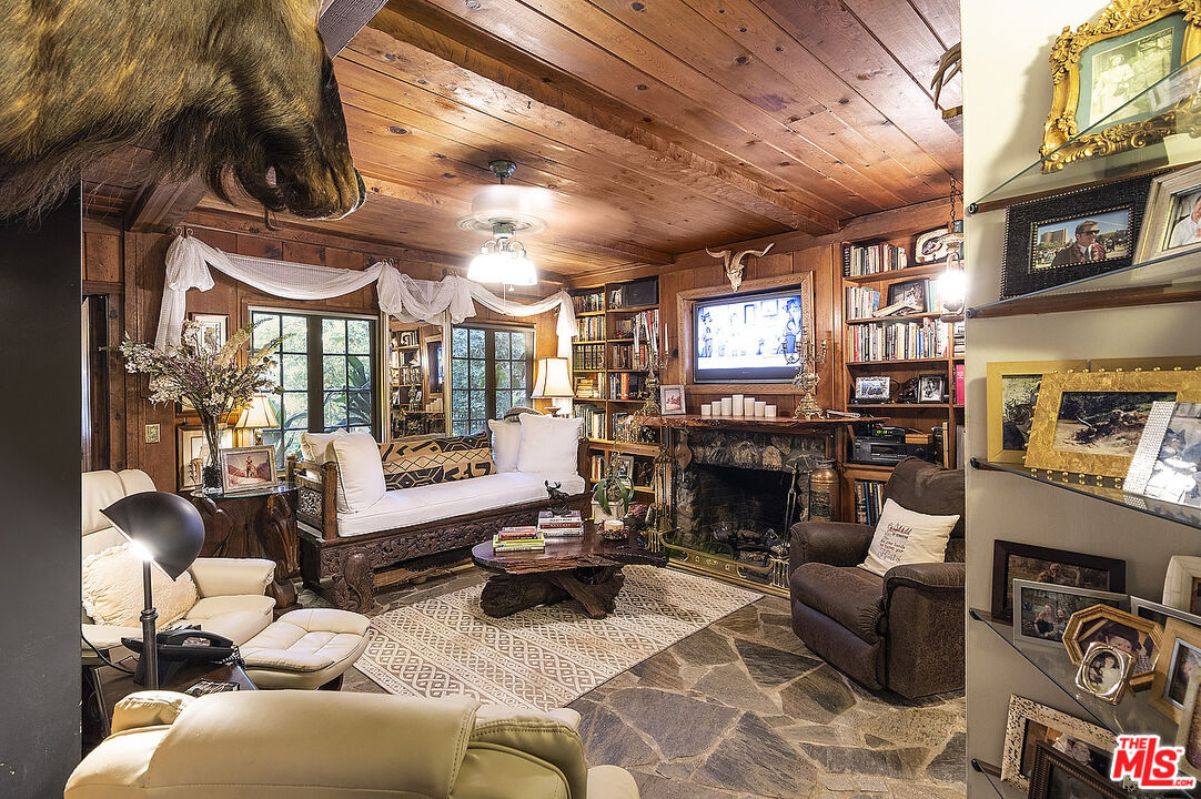 14831 Little Tujunga Canyon Road Sylmar, CA 91342 - Photo 18 of 49 a living room with furniture a fireplace and a floor to ceiling window