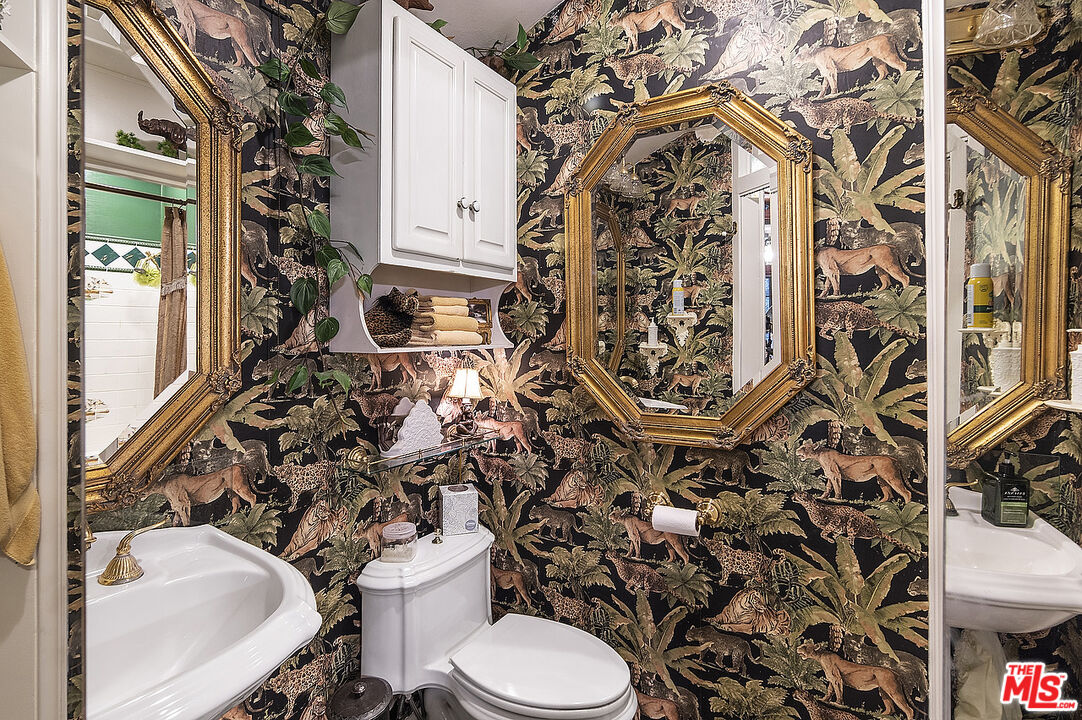 14831 Little Tujunga Canyon Road Sylmar, CA 91342 - Photo 29 of 49 a bathroom with a toilet sink and mirror