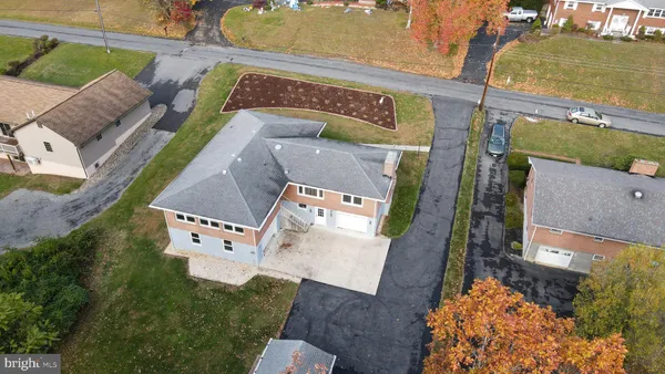 an aerial view of a house with a yard