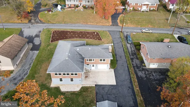 an aerial view of a house with a yard and garage