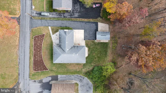 a aerial view of a house with a yard and deck