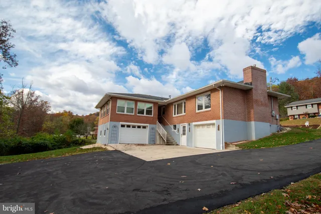 a view of empty room with wooden floor and fireplace