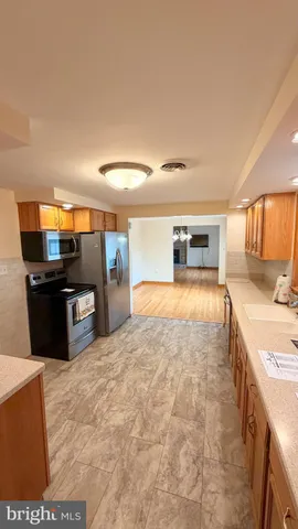 a view of a room with wooden floor and furniture