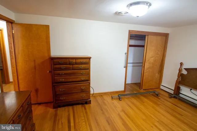 a bedroom with a bed and a green plant