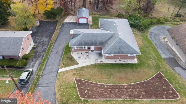 an aerial view of a house with a yard