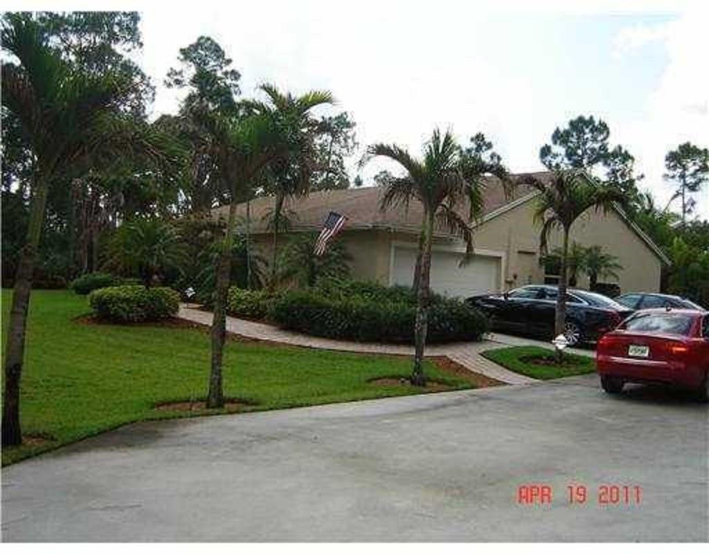 18604 Northwest 43rd Road Loxahatchee, FL 33470 - Photo 2 of 14 SIDE OF HOUSE WITH DRIVEWAY