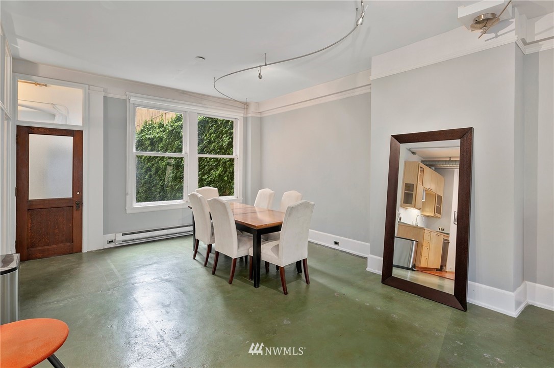 1519 3rd Avenue, Unit 302 Seattle, WA 98101 - Photo 15 of 26 a dining room with furniture and a window