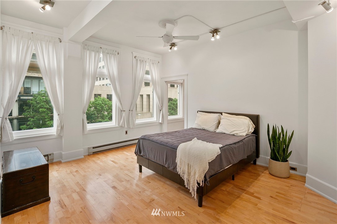 1519 3rd Avenue, Unit 302 Seattle, WA 98101 - Photo 20 of 26 a spacious bedroom with a bed and a window