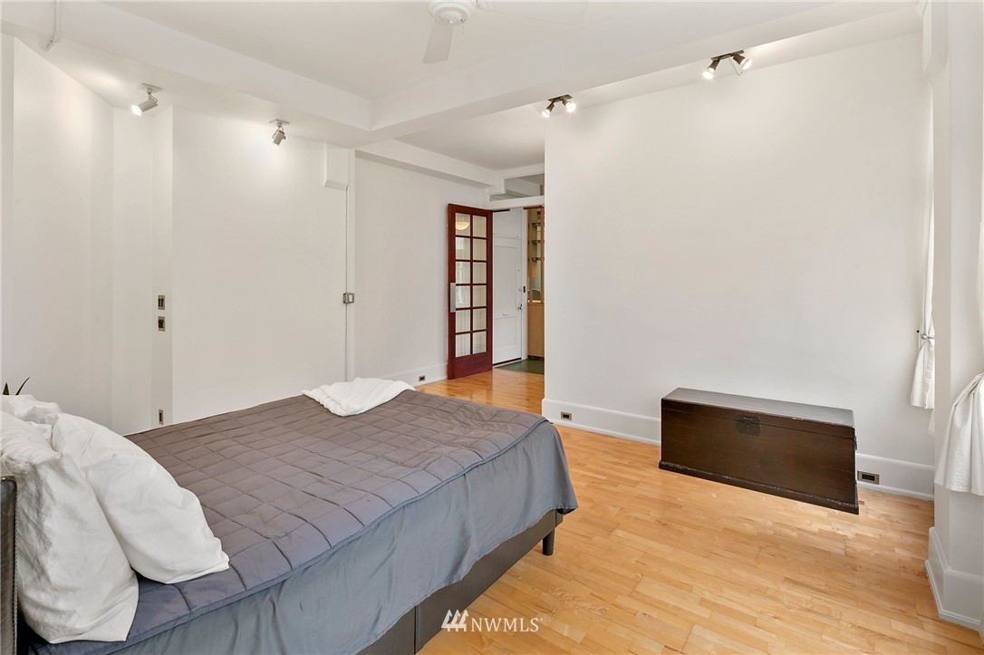 1519 3rd Avenue, Unit 302 Seattle, WA 98101 - Photo 22 of 26 a bedroom with a bed and a fireplace