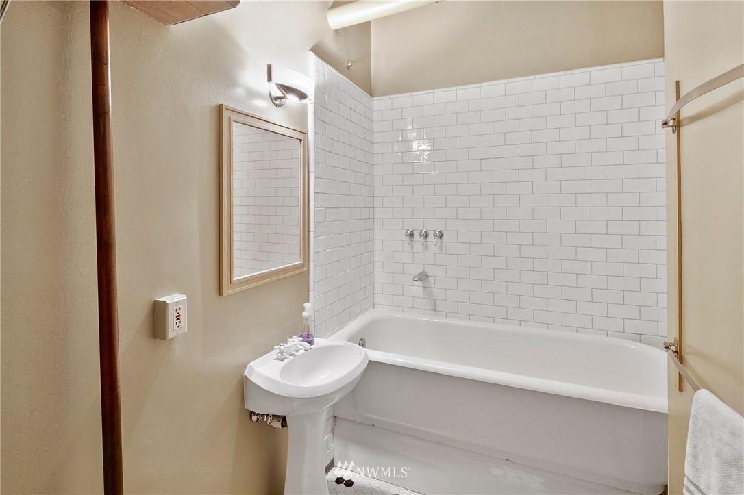 1519 3rd Avenue, Unit 302 Seattle, WA 98101 - Photo 25 of 26 a bathroom with a sink and a bathtub