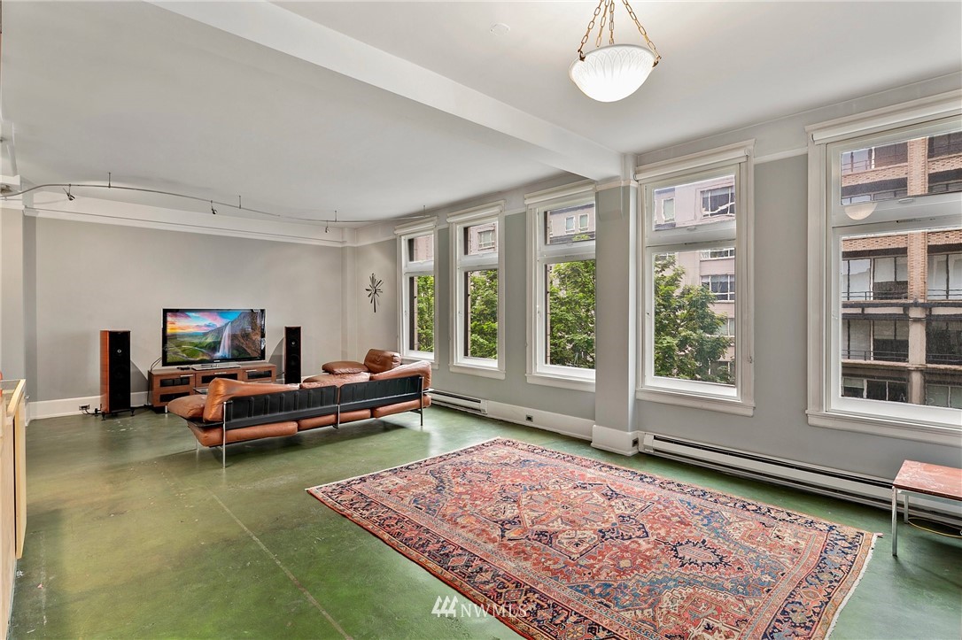1519 3rd Avenue, Unit 302 Seattle, WA 98101 - Photo 5 of 26 a living room with furniture and a rug