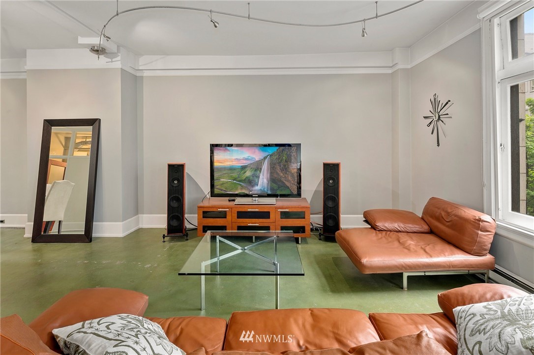 1519 3rd Avenue, Unit 302 Seattle, WA 98101 - Photo 6 of 26 a living room with furniture and a flat screen tv