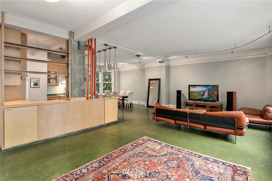 1519 3rd Avenue, Unit 302 Seattle, WA 98101 - Photo 7 of 26 a living room with furniture and a rug