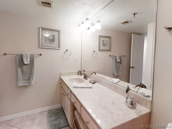 a bathroom with a sink vanity and a mirror