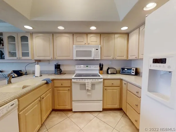 a kitchen with appliances cabinets and a sink