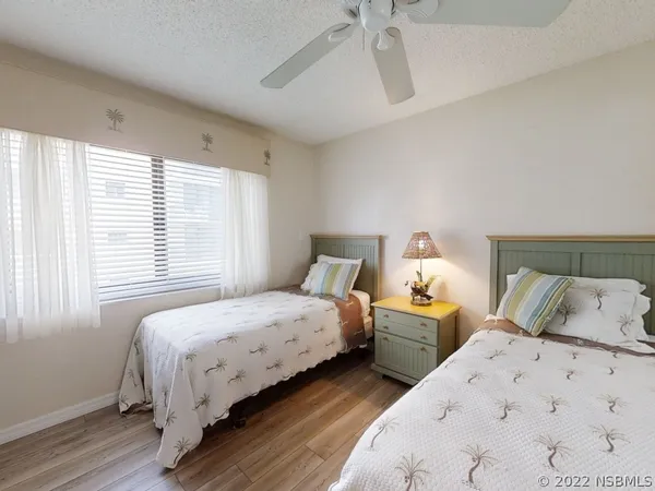 a bedroom with two beds and a window