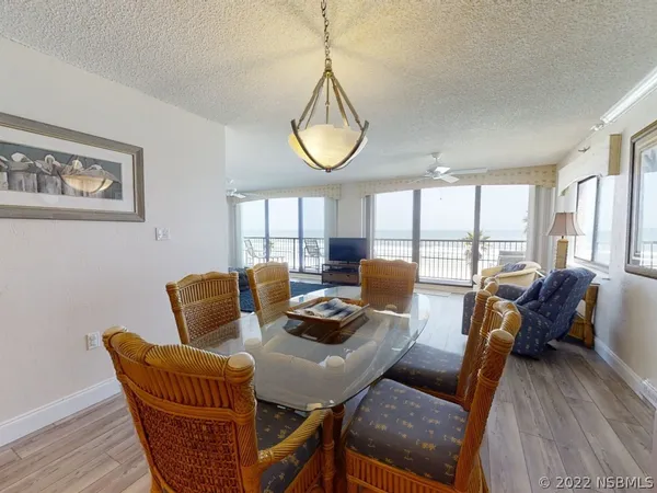 a living room with furniture a window and a floor to ceiling window