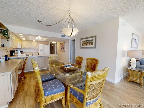 a dining room with furniture and wooden floor