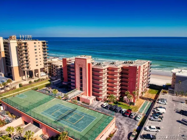 an aerial view of a tennis ground with large trees