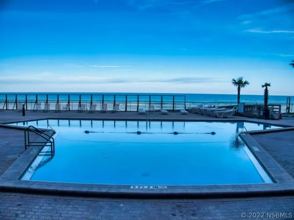 a view of a swimming pool with seating area
