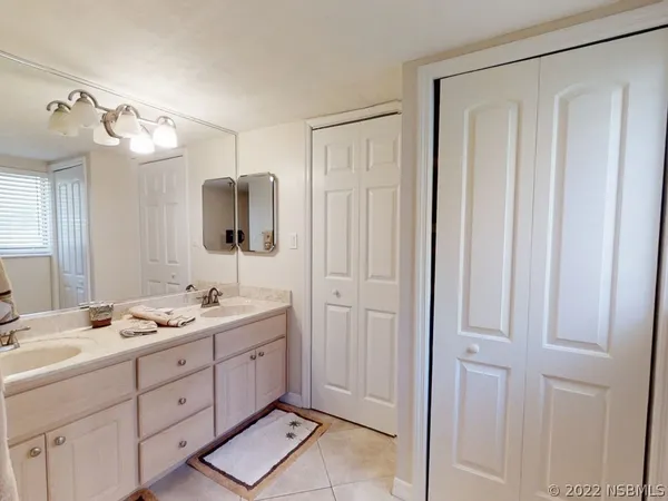 a spacious bathroom with a double vanity sink and a mirror