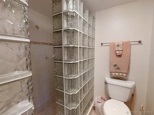 a bathroom with a toilet a sink and shower